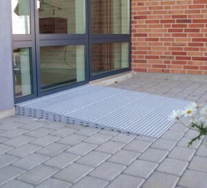 Grey plastic threshold ramp at a doorway