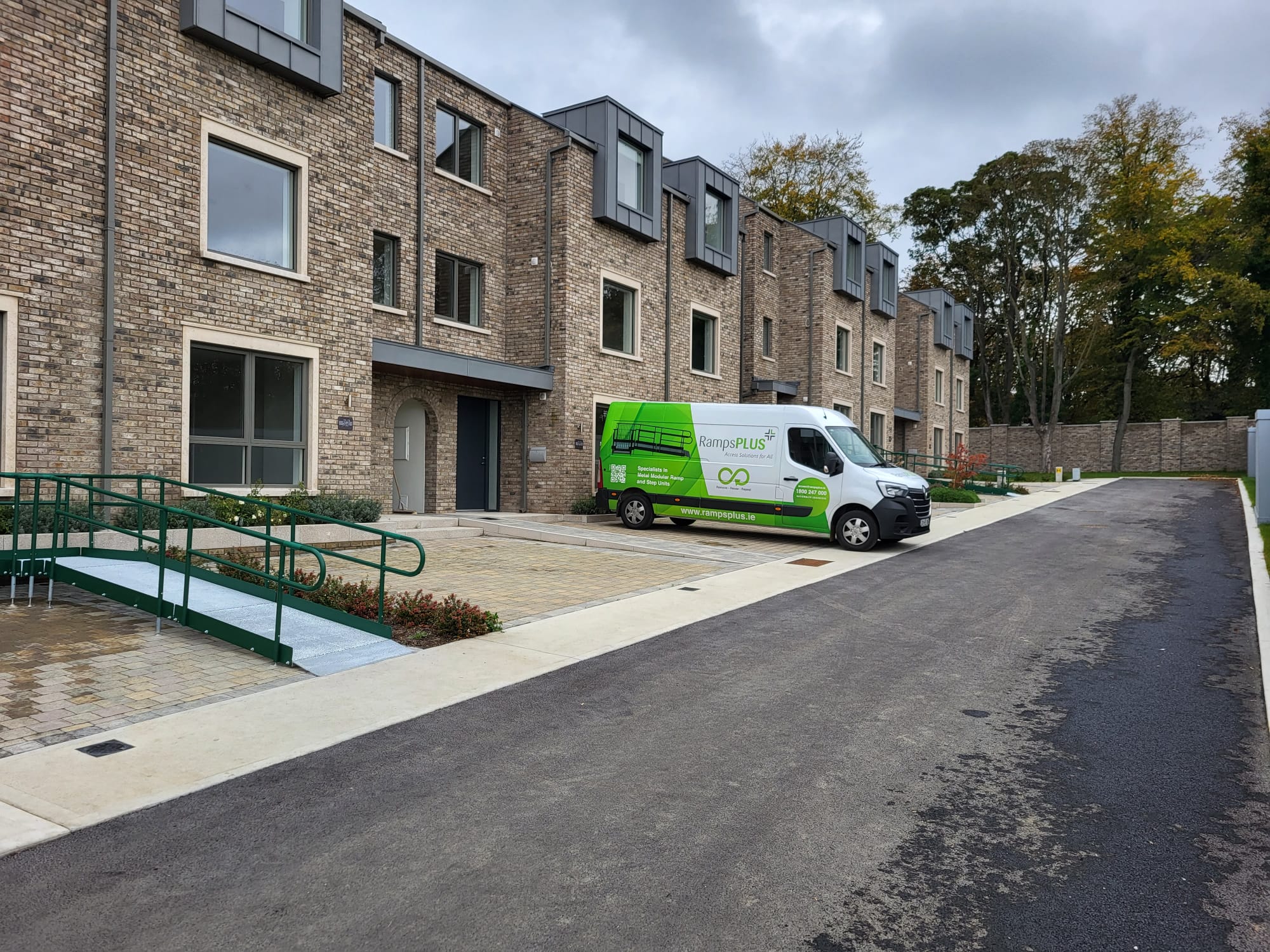 New house with access ramp in front and Ramps Plus van
