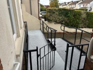 Modular ramp installed with black handrails