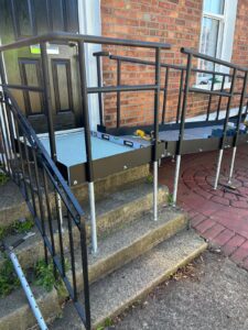 Black modular ramp on concrete steps in a conservation area