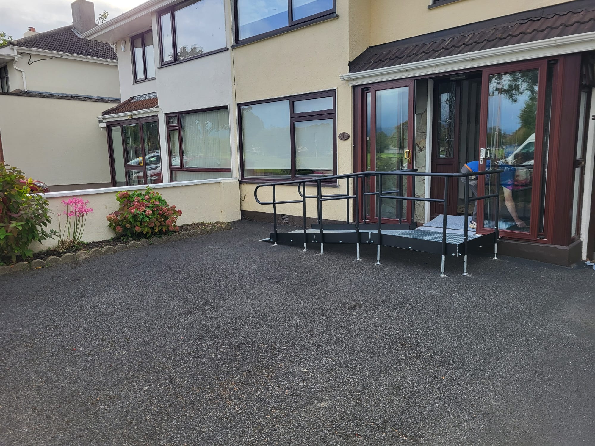 Modular ramp at the front of a house with a brown door frame