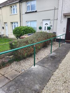 Long green handrail in front garden