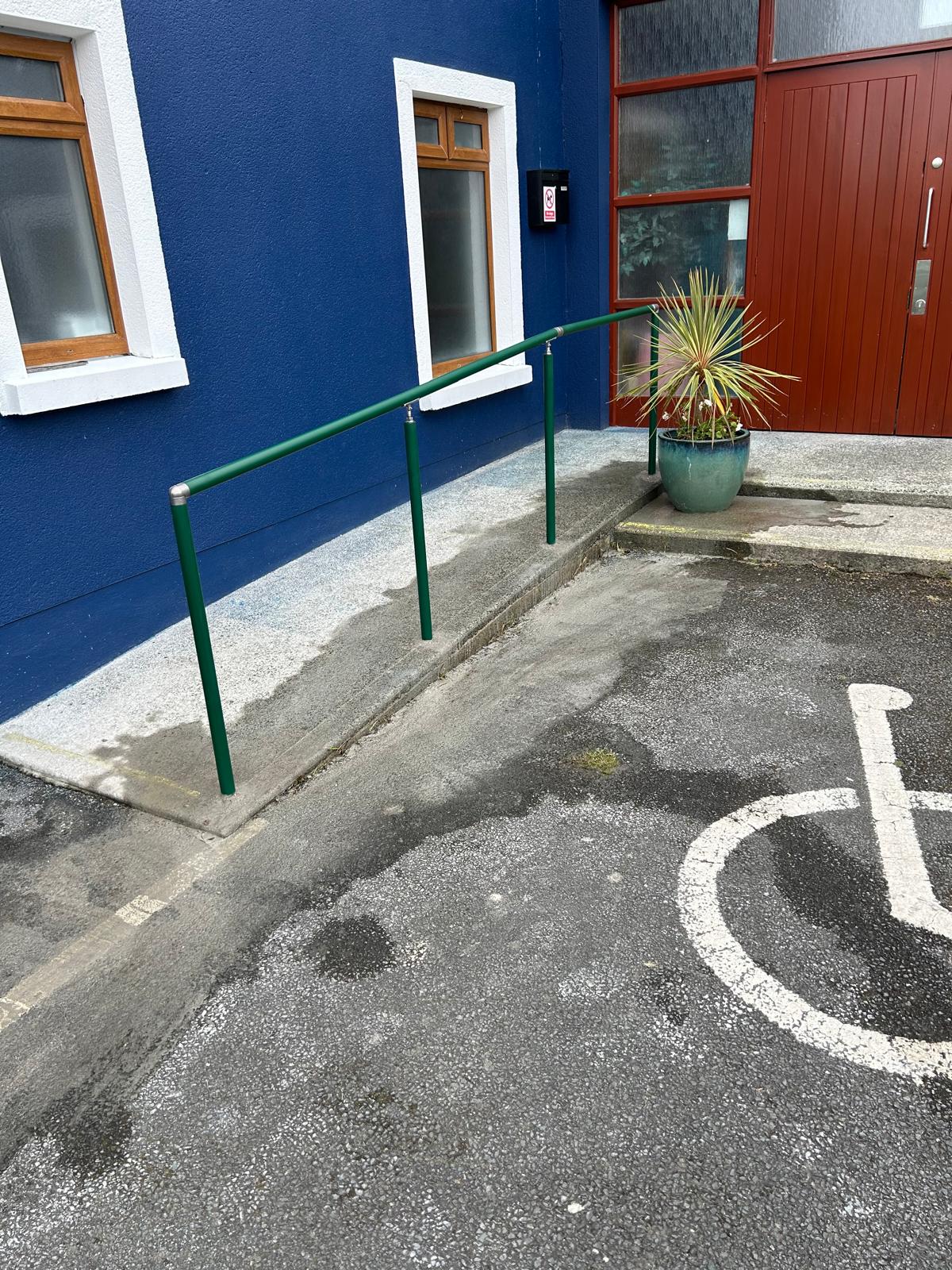 Green handrails at a community centre
